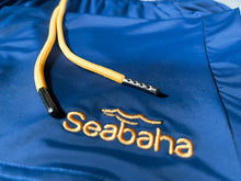 Load image into Gallery viewer, Blue swim shorts, with yellow logo and waistband
