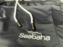 Load image into Gallery viewer, Black long swim shorts, with white logo and waistband
