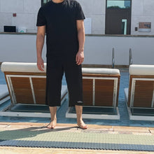 Load image into Gallery viewer, Black long swim shorts, with white logo and waistband
